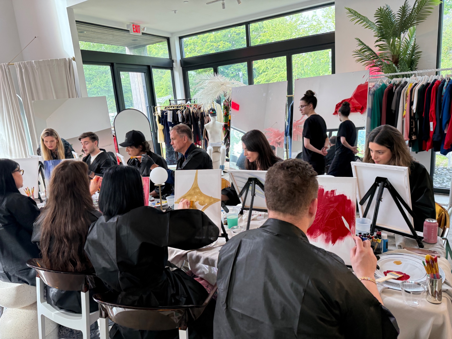 Guests painting in a bright studio during an ELARTĒ gathering