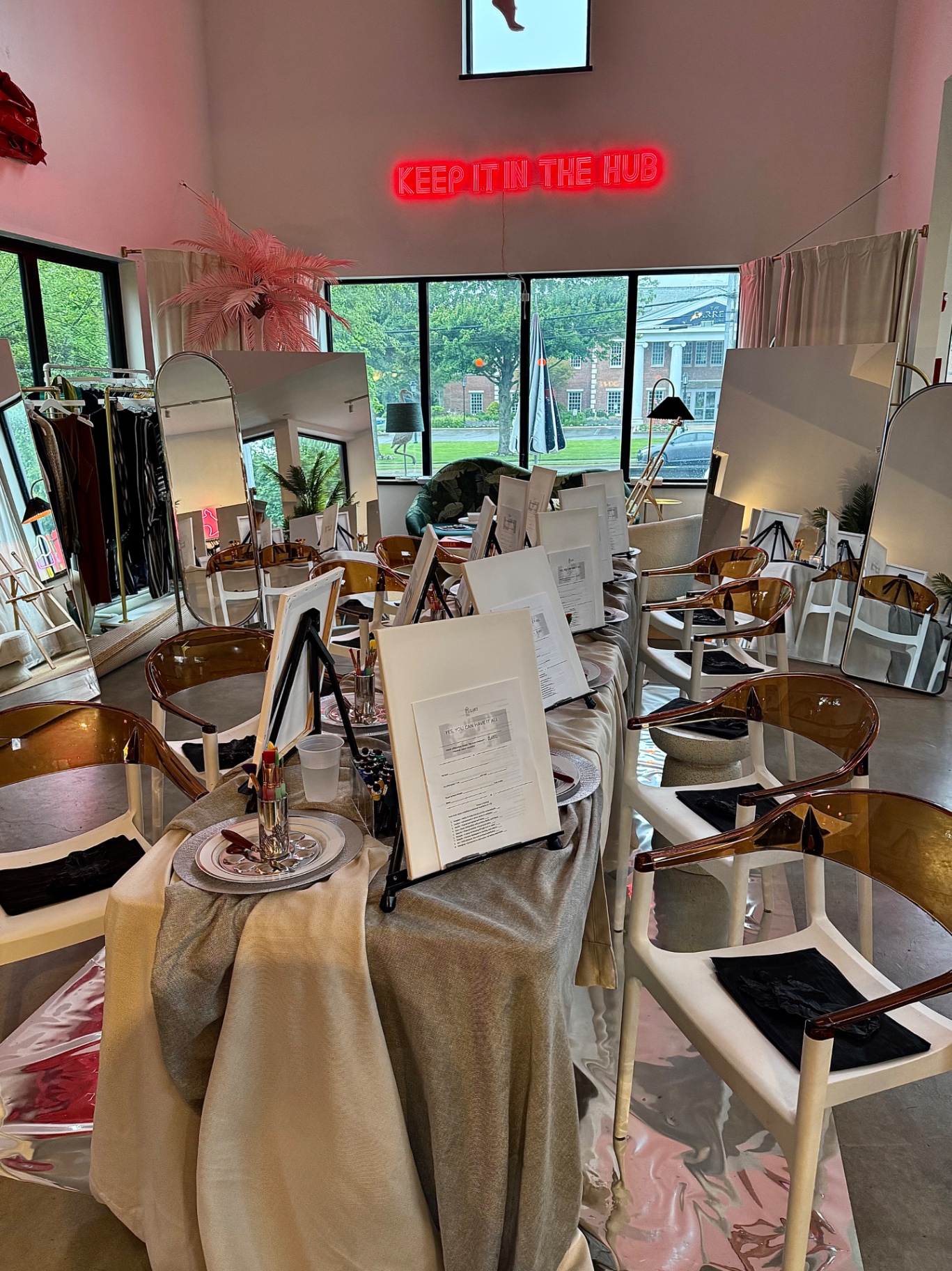 Indoor ELARTĒ event setup with canvases and mirrors